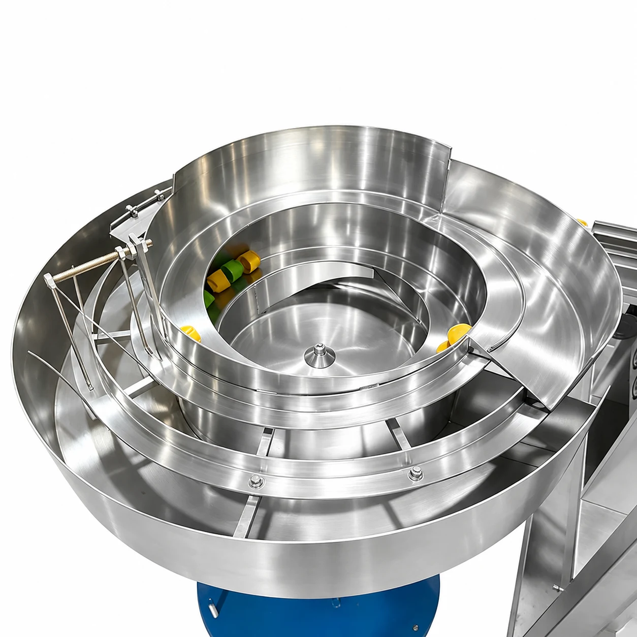 Stainless spiral bowl feeder holding colored dosing-cap components